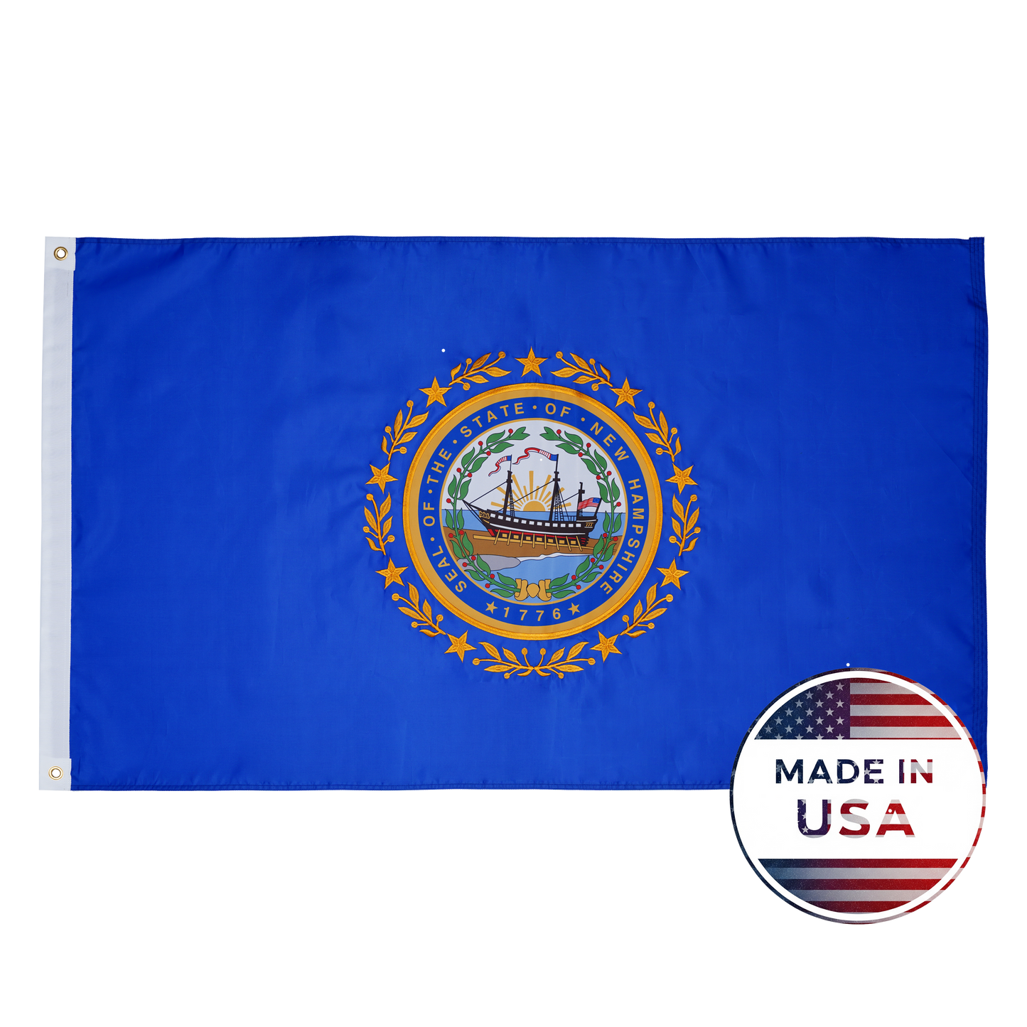 Flag Stars Inc’s New Hampshire State Flag – 100% Made in USA – features a blue background with the state seal, shown beside a round “Made in USA” American flag label. Built durable for outdoor use.