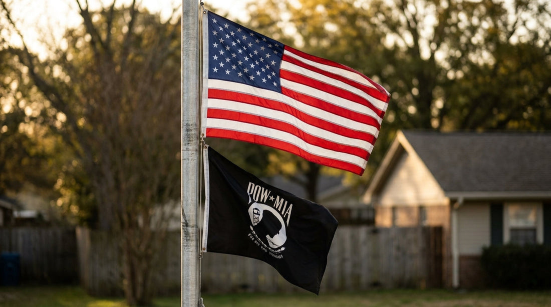 Black-and-white POW/MIA flag flying below an American flag on a residential flagpole for National POW/MIA Recognition Day 2026