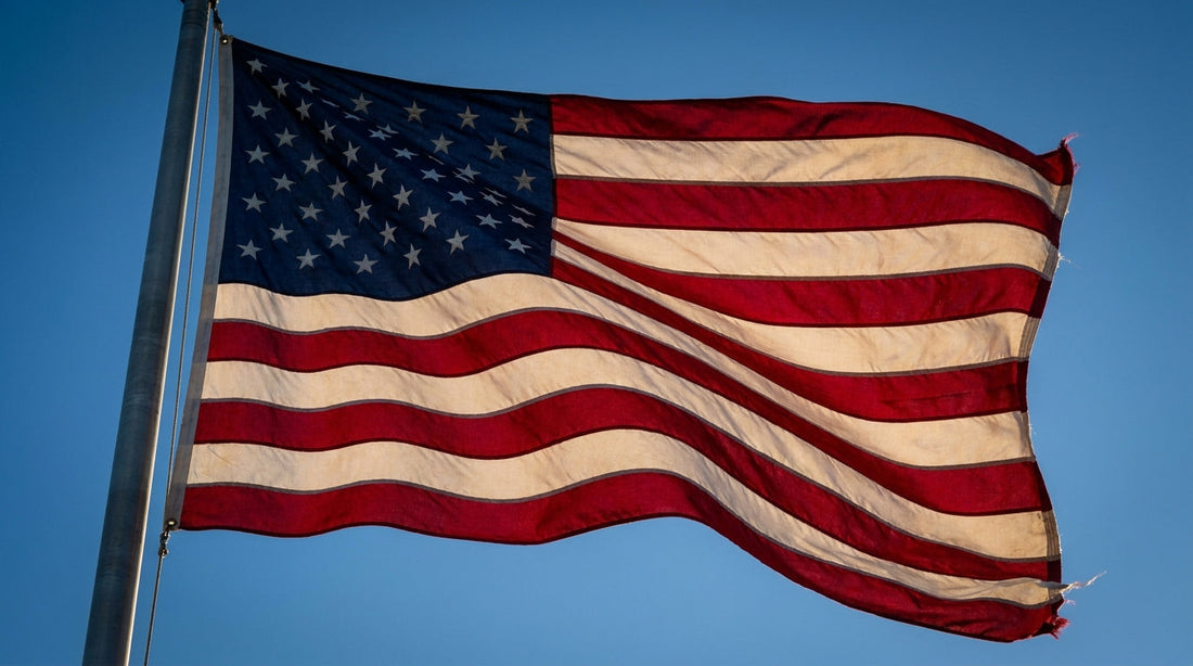 Close-up of a made-in-USA American flag showing accurate Old Glory Red stripes and Old Glory Blue canton with embroidered stars