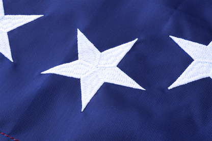 Close-up of three white embroidered stars on durable nylon with a rich blue background, from the Flag Stars Inc Nylon Betsy Ross Flag. 100% Made in USA.