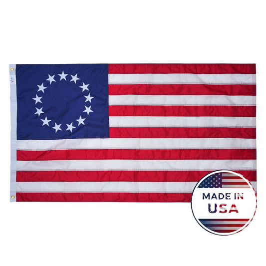 The Flag Stars Inc Nylon Betsy Ross Flag, 100% Made in USA, features 13 embroidered stars in a circle, 13 red and white stripes, and is crafted from durable nylon for lasting quality.