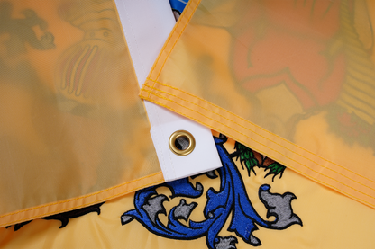 Close-up of the New Jersey State Flag by Flag Stars Inc, showing a yellow corner with metal grommet and colorful raised embroidery—100% made in USA, ideal for outdoor use.