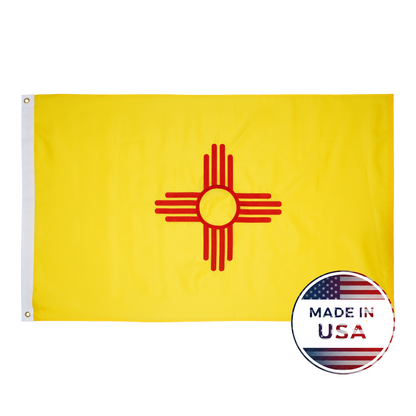 The New Mexico State Flag by Flag Stars Inc features the red Zia sun on yellow, with a "Made in USA" badge and American flag in the lower right corner. Durable and outdoor ready—perfect for showing your New Mexico pride!.