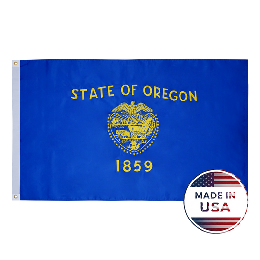 The Oregon State Flag by Flag Stars Inc features a blue background, gold state seal, “STATE OF OREGON 1859” text, raised embroidery, and comes with a "Made in USA" badge. Proudly 100% made in the USA.