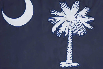 The South Carolina State Flag by Flag Stars Inc features a white palmetto and crescent on dark blue with raised embroidery for texture. 100% Made in USA.