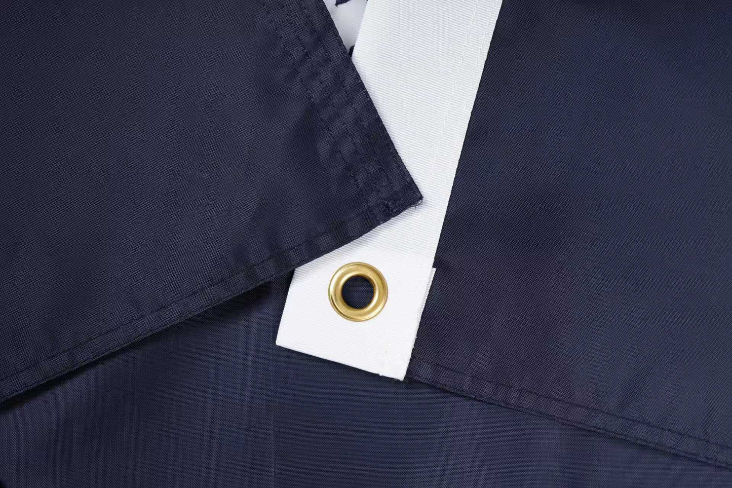 Close-up of overlapping dark blue and white fabric with a metal grommet—South Carolina State Flag by Flag Stars Inc, 100% made in the USA and built for outdoor use.