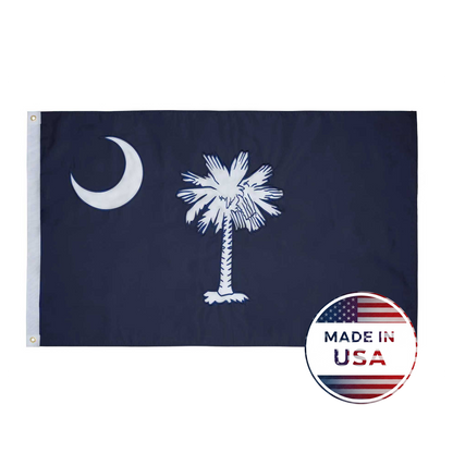 Flag Stars Inc's South Carolina State Flag - 100% Made in USA features a white palmetto and crescent on blue, raised embroidery for detail, and a "Made in USA" label. Durable construction makes it perfect for outdoor use.