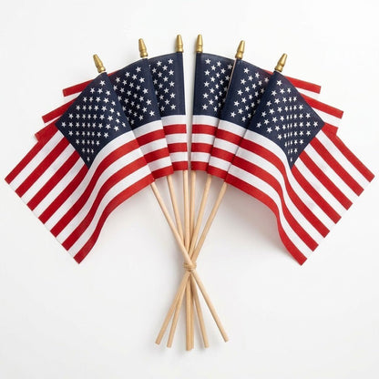Seven Flag Stars Inc Poly Cotton US Stick Flags, each with a natural wood stick and made in the USA, are fanned out on a white background—ideal for parades or decorations.